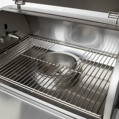 A clean, stainless steel interior of a pellet smoker with grates, ready for cooking