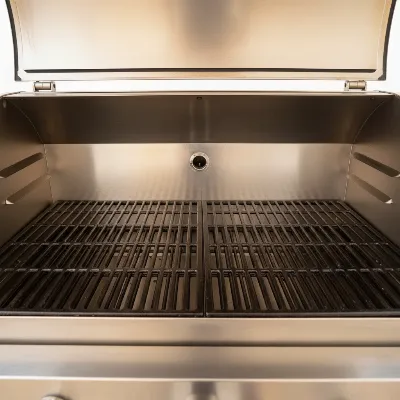 A newly seasoned pellet smoker with a clean, well-maintained interior, ready for its first cooking session.